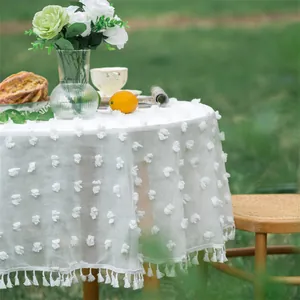French style white round tablecloth with 3D dot jacquard and fringe on garden lawn