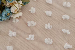 Detail of white pom-pom fringe on light brown sheer polyester curtains for home decor