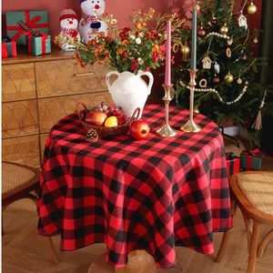 Detail of red and black buffalo plaid round tablecloth with cozy Christmas decor