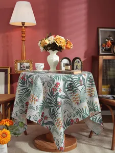 Detail of tropical floral cotton linen tablecloth with palm leaf and hibiscus print