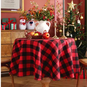 Detailed view of round red and black buffalo plaid Christmas tablecloth with neat edges