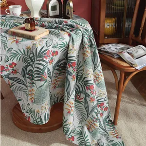 Detailed view of heavy cotton linen tablecloth with tropical green leaves and floral print