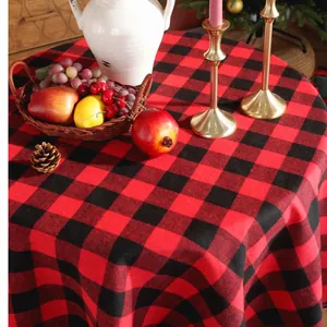 Detailed view of red and black buffalo plaid round tablecloth with festive holiday decor
