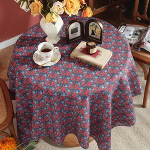 Detail of round linen tablecloth with vintage floral patterns for an elegant tea time