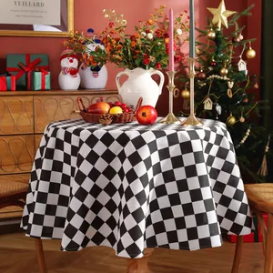 Detailed view of black and white checkered round tablecloth with elegant drape for holidays