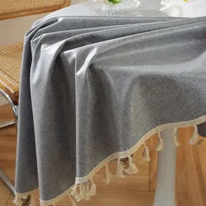 Detail der grauen wasserdichten Tischdecke mit eleganten cremefarbenen Quasten