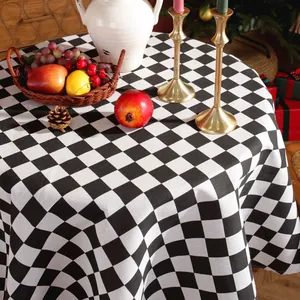 Detail of round black and white checkered tablecloth in a festive Christmas dining setting