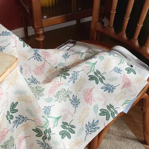 Close-up of premium linen-cotton blend tablecloth featuring fresh floral print patterns