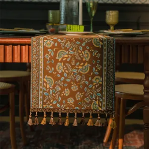 Dettaglio runner da tavola vintage boho con motivi etnici jacquard e nappe decorative