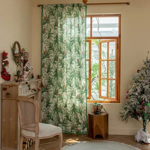 Nordic style green pine needle print curtains with pom pom tassels in cozy home setting