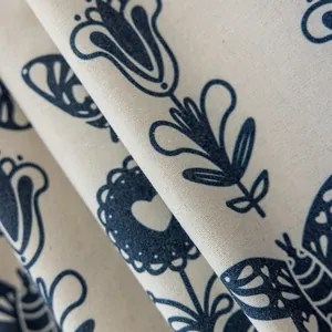 Detailed texture of cotton linen fabric featuring navy blue folk art floral printing