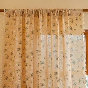 Close-up of semi-blackout floral curtain with decorative white tassels and linen texture
