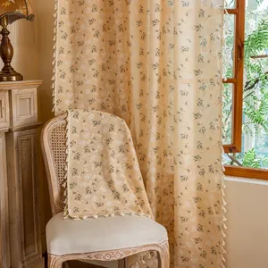 Close-up of rustic floral semi-blackout curtain with fringe trim and cotton linen texture