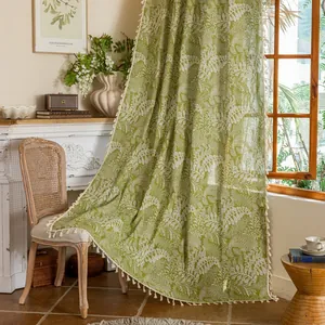 Green Nordic curtain with white leaf patterns and cream tassel edges for windows
