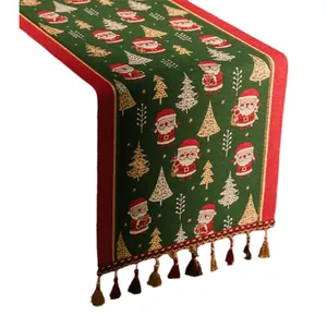 Runner da tavola natalizio in jacquard con motivi Babbo Natale e nappe colorate