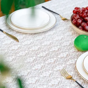 Detail of white bohemian lace tablecloth with intricate hollow floral knit patterns