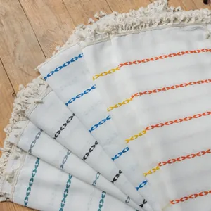 Macro detail of bohemian striped polyester fabric with handmade fringe and embroidery