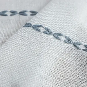 Macro shot of striped polyester curtains showing weave texture and embroidered details