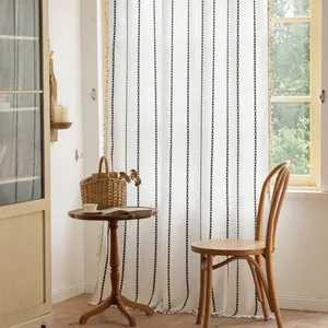 Beige striped semi-sheer curtains with black geometric patterns and tassel edges for living room