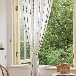 Detailed texture of white polyester curtain with black diamond embroidery and tie-back rope