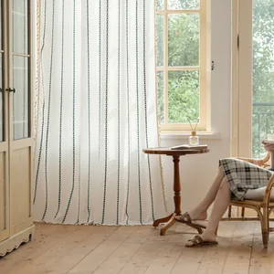 Minimalist beige striped curtains with green vertical patterns and tassel fringe details