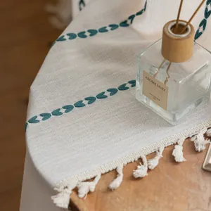 Macro shot of boho striped polyester curtain fabric with green heart embroidery and tassels