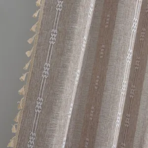 Detail of light coffee striped curtain with diamond embroidery and tassel trim texture