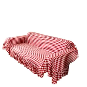 Red and white checkered sofa cover with ruffled edges and minimalist Nordic design style