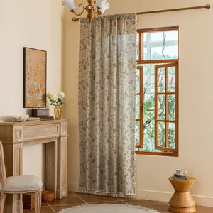 Detail of floral linen curtain with fringe trim and retro botanical pattern in natural light