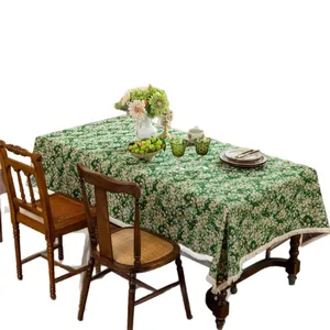 Forest green floral tablecloth with white daisy patterns and elegant tassel edges