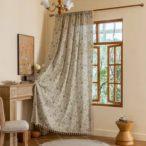 Vintage floral semi-blackout curtain with white pom-pom fringe in a warm bedroom setting