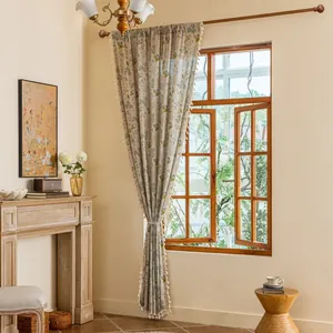 Detail of floral curtain with side tassels and rustic cotton linen fabric texture
