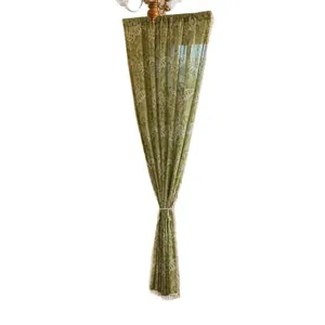 Grass green curtain with white leaf patterns and tie-back for a stylish window display