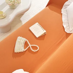 Detailed texture of orange cotton sofa cover with elegant ruffle edge in home setting