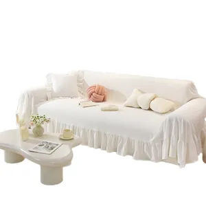 Solid white cotton sofa cover with ruffled edges and waffle texture in minimalist style
