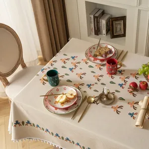 Detail of Christmas tablecloth with reindeer pattern and white pom-pom tassel fringe
