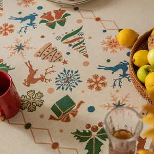 Detailed view of jacquard Christmas tablecloth featuring reindeer and snowflake patterns