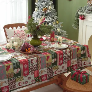 Detailed patchwork Christmas tablecloth with Santa and reindeer motifs in festive colors
