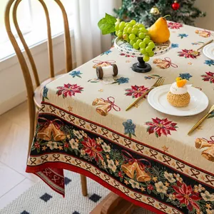 Detailed jacquard Christmas tablecloth featuring festive poinsettia and bell patterns