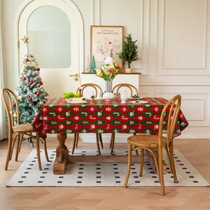 Macro detail of red and green jacquard Christmas tablecloth with Santa and gingerbread pattern