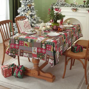 Close-up of festive jacquard Christmas tablecloth with reindeer and snowman patterns