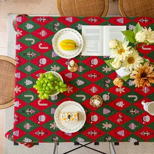 Macro shot of thick red and green Christmas jacquard tablecloth with festive patterns