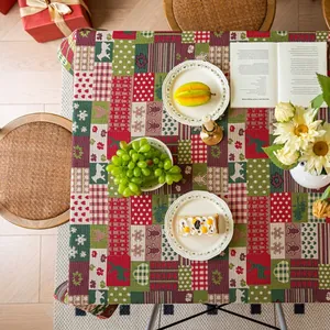 Detail of festive Christmas patchwork tablecloth with reindeer and snowflake patterns