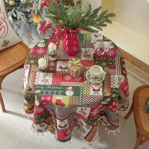 Close-up of red Christmas tablecloth with tassel fringe and festive reindeer patterns