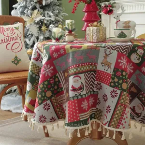 Close-up of festive red Christmas jacquard tablecloth with snowmen and tassel edges