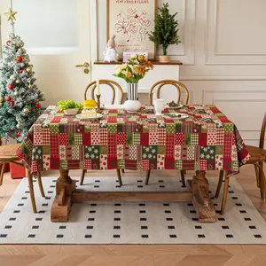 Detail of festive red and green Christmas patchwork tablecloth on a dining table