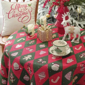 Detail of red and green jacquard tablecloth with Christmas patterns and festive tassels
