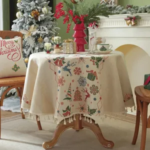 Detailed close-up of Christmas round tablecloth with festive jacquard and tassel edge