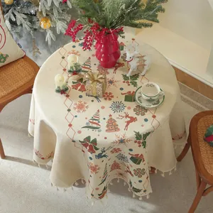 Close-up of beige Christmas tablecloth featuring festive reindeer and snowflake jacquard
