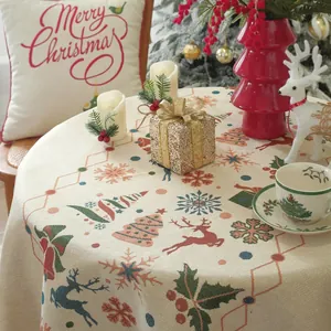 Close-up of red Christmas jacquard patterns with reindeer and trees on round tablecloth